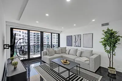 a living room with a couch and a table at Miami Beach Paradise 4BR Stylish condo with Resort Perks 1007 in Miami Beach