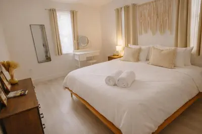 a bedroom with a large white bed with towels on it at Prime Location Home W BBQ & Free Parking in Miami