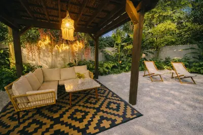 a patio with a couch and two chairs and a chandelier at Prime Location Home W BBQ & Free Parking in Miami