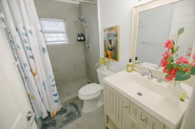 a bathroom with a toilet and a sink and a shower at Prime Location Home W BBQ & Free Parking in Miami