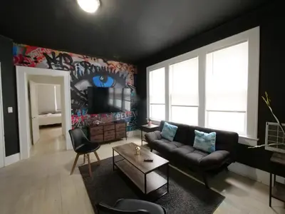 a living room with a couch and a tv at Stylish Miami retreat-Edgewater in Miami