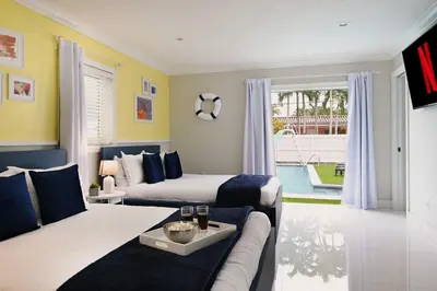 a bedroom with a bed and a couch and a living room at Olympia LUX House 4BR, Heated POOL, BBQ, BAR in Miami