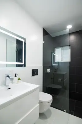 a bathroom with a toilet and a sink and a shower at Olympia LUX House 4BR, Heated POOL, BBQ, BAR in Miami