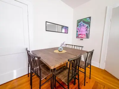 a dining room with a wooden table and chairs at Central & Stylish Miami Getaway in Miami
