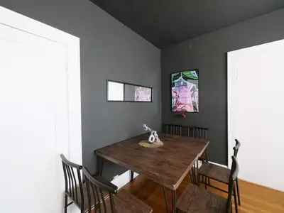 a dining room with a wooden table and chairs at Central & Stylish Miami Getaway in Miami
