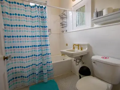 a bathroom with a shower curtain and a toilet and a sink at Central & Stylish Miami Getaway in Miami