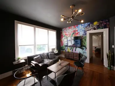 a living room with a couch and a wall with graffiti at Central & Stylish Miami Getaway in Miami