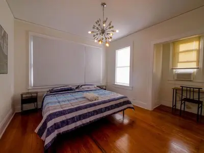 a bedroom with a bed and a chandelier at Central & Stylish Miami Getaway in Miami