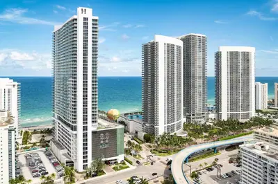 an aerial view of a city with tall buildings and the ocean at Event-Ready 2BR 2BA Near Stadium & Beach includes Parking and Washer and Dryer in Hallandale Beach