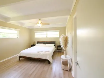 a bedroom with a bed and a ceiling fan at 3BD Tropical Luxe Stay with Pool, Gameroom and Grill in Fort Lauderdale