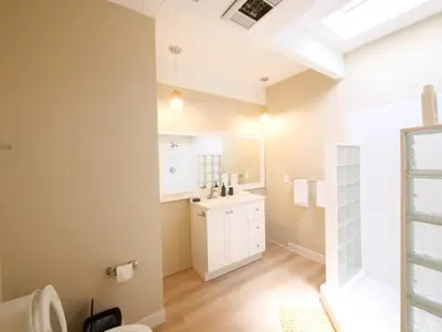 a bathroom with a sink and a toilet at 3BD Tropical Luxe Stay with Pool, Gameroom and Grill in Fort Lauderdale