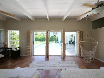 a bedroom with a bed and sliding glass doors at 3BD Tropical Luxe Stay with Pool, Gameroom and Grill in Fort Lauderdale
