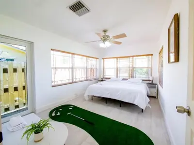a bedroom with a bed and a large window at Dania Beach 3-bedroom house - Pool,Parking,Grill in Dania Beach
