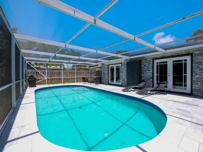 a swimming pool on a patio with a roof at Dania Beach 3-bedroom house - Pool,Parking,Grill in Dania Beach