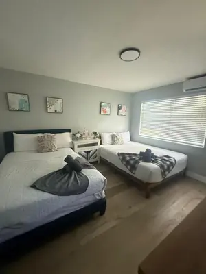 a bedroom with two beds and a window at 2 Beach Units for 6 | Patio + Free Parking in Dania Beach