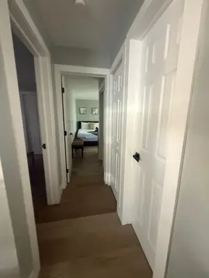 a hallway leading to a room with a bed at 2 Beach Units for 6 | Patio + Free Parking in Dania Beach