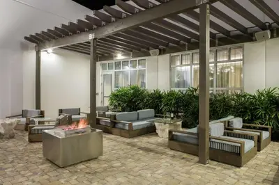 a patio with couches and a fire pit at Hilton Garden Inn Miami Dolphin Mall in Miami