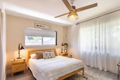 a bedroom with a bed and a ceiling fan at 2BD 2BA Bungalow 5 min Dania Beach 15 min Hard Rock Stadium in Dania Beach