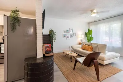 a living room with a couch and a chair at 2BD 2BA Bungalow 5 min Dania Beach 15 min Hard Rock Stadium in Dania Beach