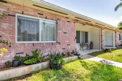 a brick house with a window and a patio at 2BD 2BA Bungalow 5 min Dania Beach 15 min Hard Rock Stadium in Dania Beach