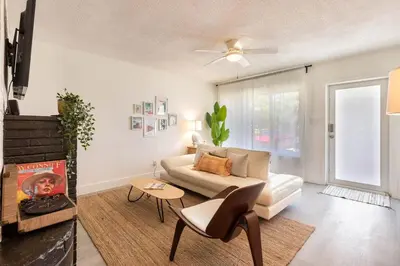 a living room with a couch and a table at 2BD 2BA Bungalow 5 min Dania Beach 15 min Hard Rock Stadium in Dania Beach