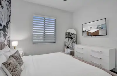 a white bedroom with a bed and a window at New Construction Villa HotTub Heated Pool Gameroom in Fort Lauderdale