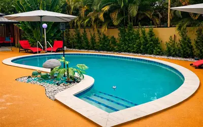 a swimming pool with an umbrella and chairs at Garden of Manors - Men Only Clothing Optional Boutique Guesthouse in Florida in Fort Lauderdale