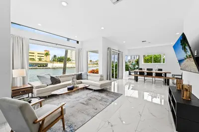 a living room with a view of the water at Villa Harrison . in Hollywood