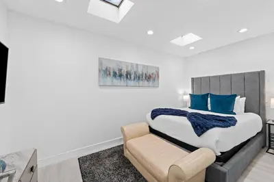 a bedroom with a bed and a couch at Villa Harrison . in Hollywood