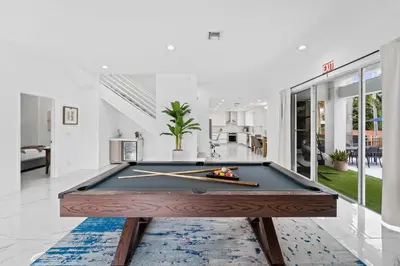 a pool table in the middle of a room at Villa Harrison . in Hollywood