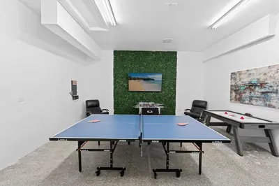 a ping pong room with two ping pong tables at Villa Harrison . in Hollywood