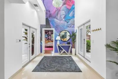 a hallway with a mural on the wall at Luxe 5BR 4BA I Heated Pool 10 Min to Beach I BBQ in Fort Lauderdale