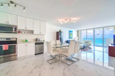 a kitchen and dining room with a table and chairs at Ocean Breeze Retreat in Miami Beach in Miami Beach