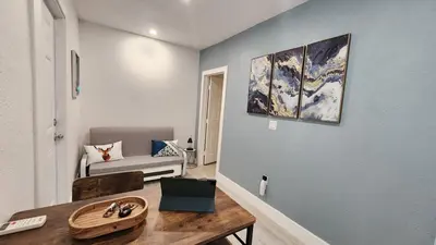 a living room with a table and a couch at Blue Loft305 in Hialeah