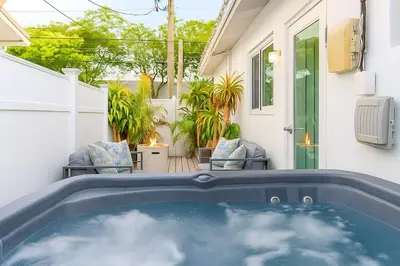 a hot tub in the backyard of a house at Steps from Airport Hot Tub Bbq Boat Slip in Dania Beach