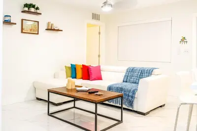 a living room with a white couch and a table at Waterfront HotTub Steps from the Airport Boat Slip in Dania Beach