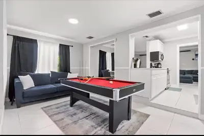 a living room with a pool table and a couch at Homeaway Haven in Fort Lauderdale