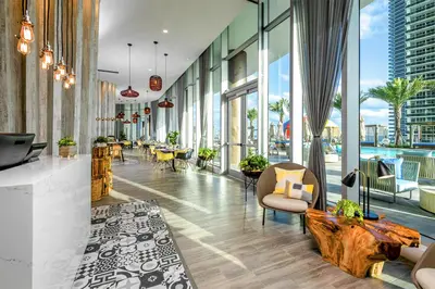 a lobby of a building with a pool at Oceanfront Retreat Steps from Hollywood Beach in Hollywood