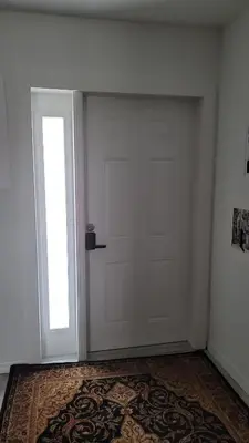 a white door in a room with a rug at Nassau Homestay in Opa-locka