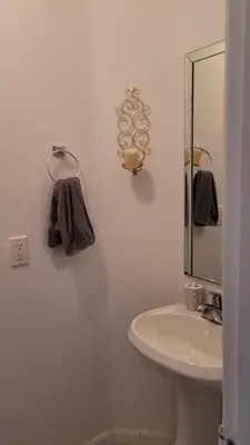 a bathroom with a sink and a mirror at Nassau Homestay in Opa-locka