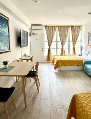 a hotel room with a bed and a desk and a table at OCEAN DRIVE-Beach Art Deco-2Queen,Cocina,Tv Wifi in Miami Beach
