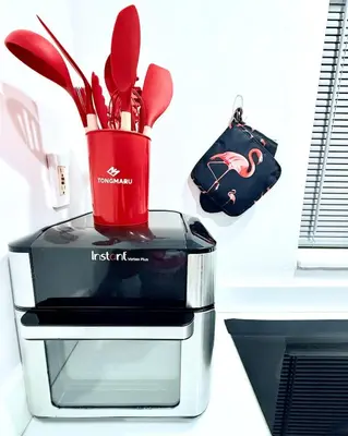 a red container with utensils in it on a counter at OCEAN DRIVE-Beach Art Deco-2Queen,Cocina,Tv Wifi in Miami Beach