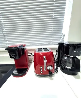 three toasters sitting on a counter next to a window at OCEAN DRIVE-Beach Art Deco-2Queen,Cocina,Tv Wifi in Miami Beach
