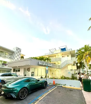 a green car parked in front of a building at OCEAN DRIVE-Beach Art Deco-2Queen,Cocina,Tv Wifi in Miami Beach