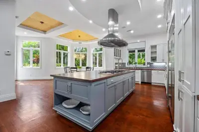 a large kitchen with white walls and a large island at New Luxe Super Villa by The Glam Homes in Plantation