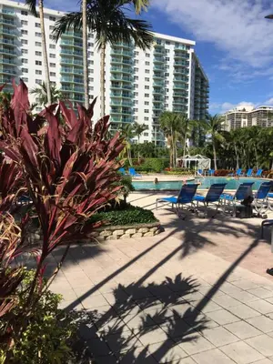 a resort with chairs and a swimming pool and buildings at Ocean Reserve STR-01045 in Miami Beach