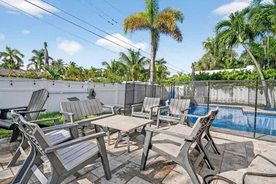 a patio with chairs and a table and a pool at Hollywood Crest by Rove Travel - Home with Heated Pool in Hollywood
