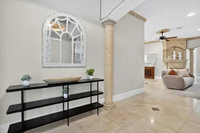a living room with a table and a chair at Hollywood Crest by Rove Travel - Home with Heated Pool in Hollywood
