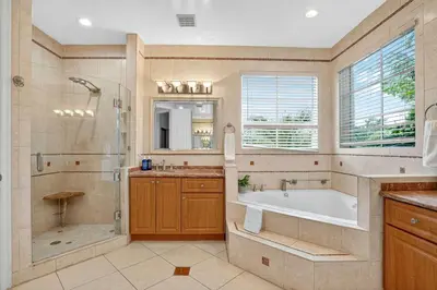 a bathroom with a tub and a shower and a sink at Hollywood Crest by Rove Travel - Home with Heated Pool in Hollywood