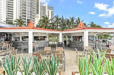 a patio at a restaurant with tables and chairs at Sunny Isles Oceanfront Apartment for Two in Sunny Isles Beach